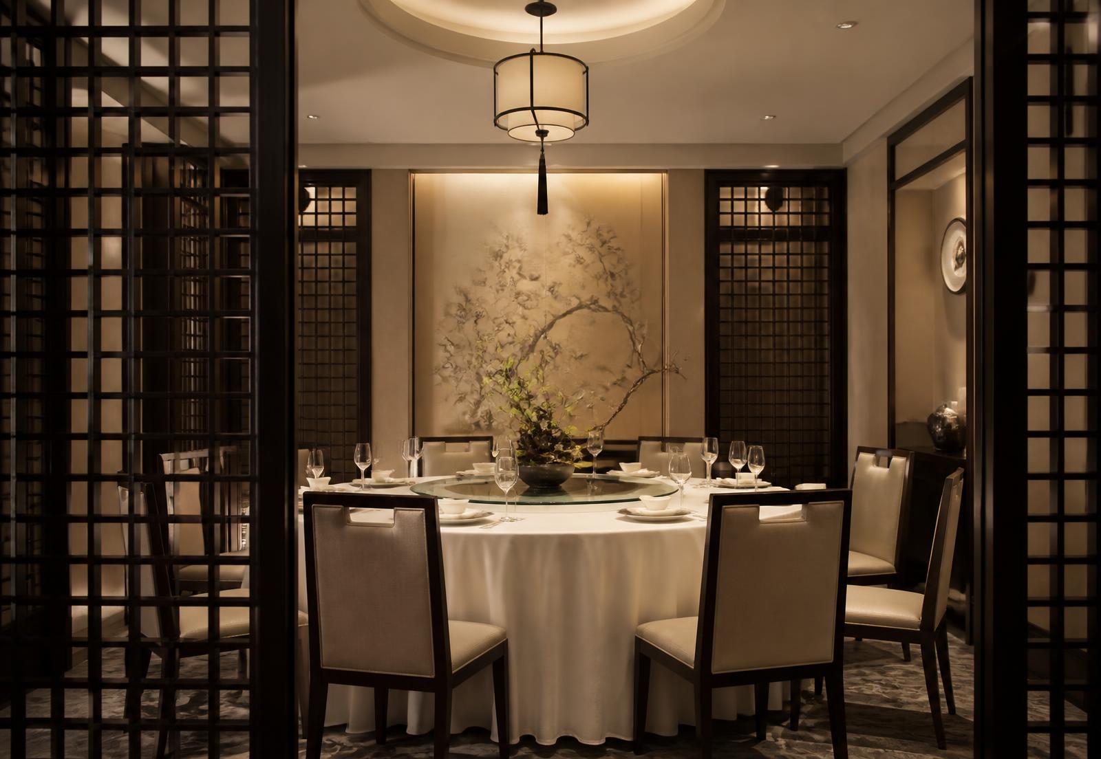 Private dining room with a round table and warm lighting